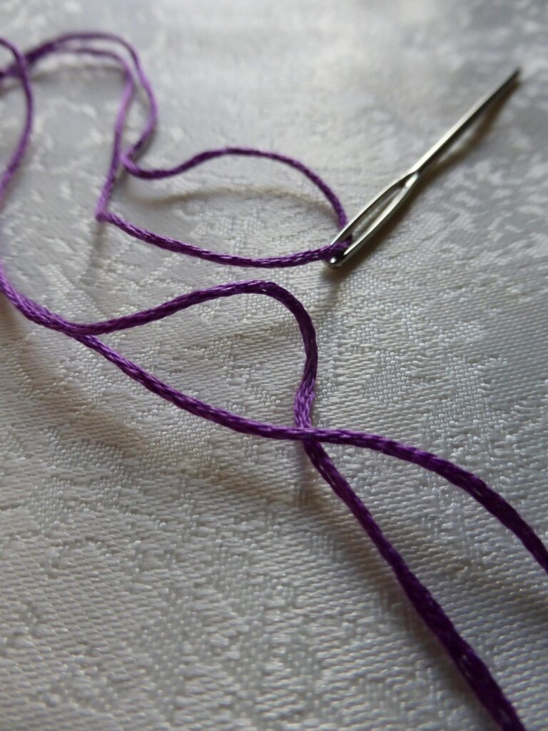 darning needle and yarn
